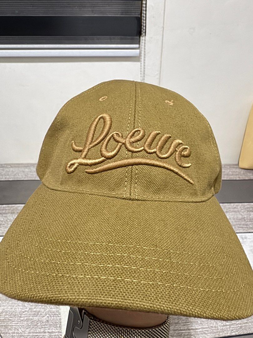 Loewe cap (Category: Caps & Hats) located in Imus. Submitted by erisoncelovesph (Listing ID 1342682001, Image 2). Description: Brand new and unused Loewe cap in olive. Size 57. Bought from Loewe Greenbelt last 11/24. Bought as a gift but got the wrong size so it was never used. With dust bag, paper bag and receipt with my name. Selling below SRP. Original price: P25,500 For meet up within MM. If delivery, SF to be shouldered by buyer. Price is sl
