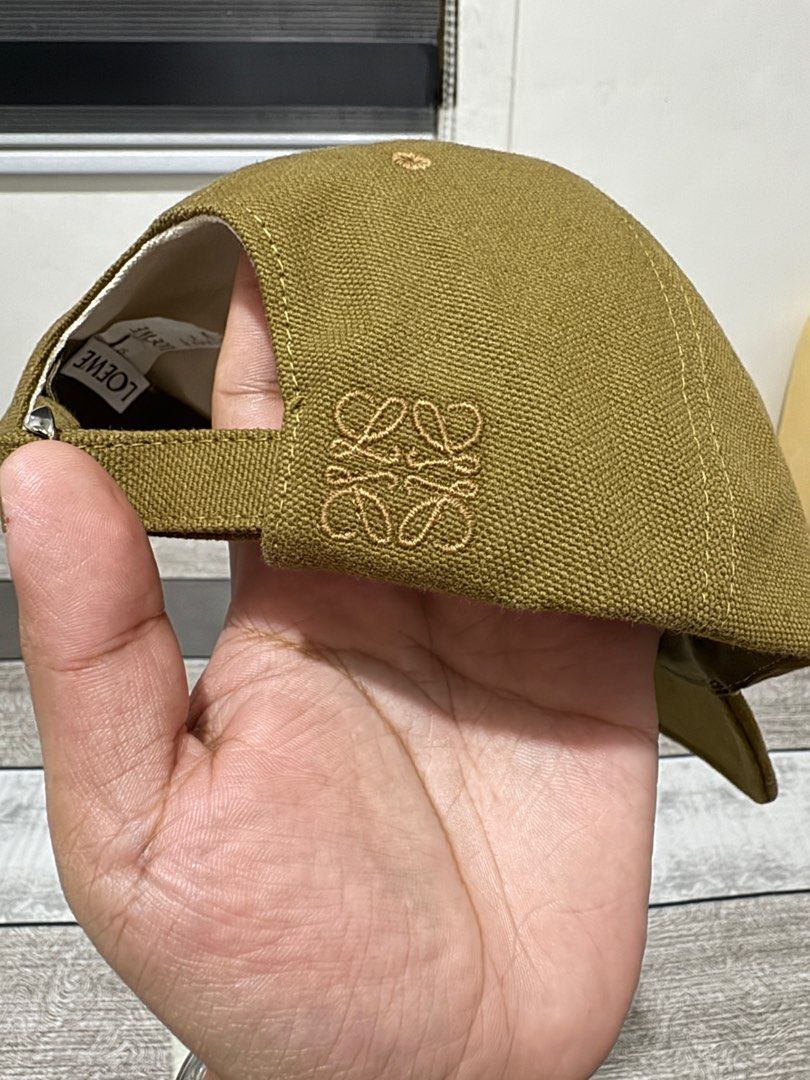 Loewe cap (Category: Caps & Hats) located in Imus. Submitted by erisoncelovesph (Listing ID 1342682001, Image 3). Description: Brand new and unused Loewe cap in olive. Size 57. Bought from Loewe Greenbelt last 11/24. Bought as a gift but got the wrong size so it was never used. With dust bag, paper bag and receipt with my name. Selling below SRP. Original price: P25,500 For meet up within MM. If delivery, SF to be shouldered by buyer. Price is sl