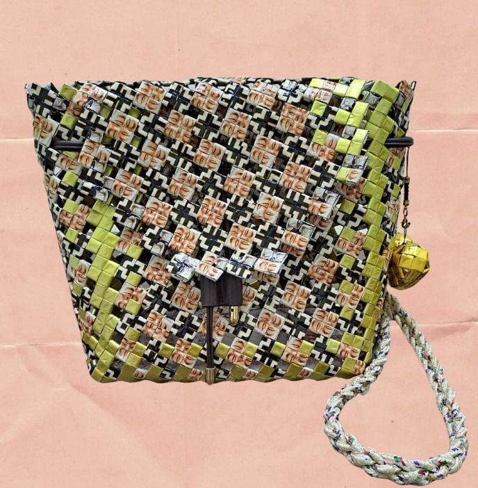 Midnight Gleam (Category: Backpacks) located in Singapore. Submitted by bcaresg (Listing ID 1342522944, Image 1). Description: Backpack made from recycled materials Dimensions: W: 27 cm, H: 24 cm Carry your essentials in sustainable style with this eye-catching crossbody bag, meticulously handwoven from recycled materials. The intricate woven pattern showcases a striking combination of black, white, yellow, and brown. The comfortable strap ensure