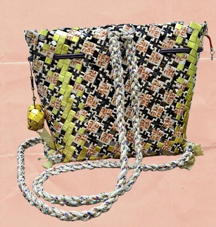 Midnight Gleam (Category: Backpacks) located in Singapore. Submitted by bcaresg (Listing ID 1342522944, Image 2). Description: Backpack made from recycled materials Dimensions: W: 27 cm, H: 24 cm Carry your essentials in sustainable style with this eye-catching crossbody bag, meticulously handwoven from recycled materials. The intricate woven pattern showcases a striking combination of black, white, yellow, and brown. The comfortable strap ensure
