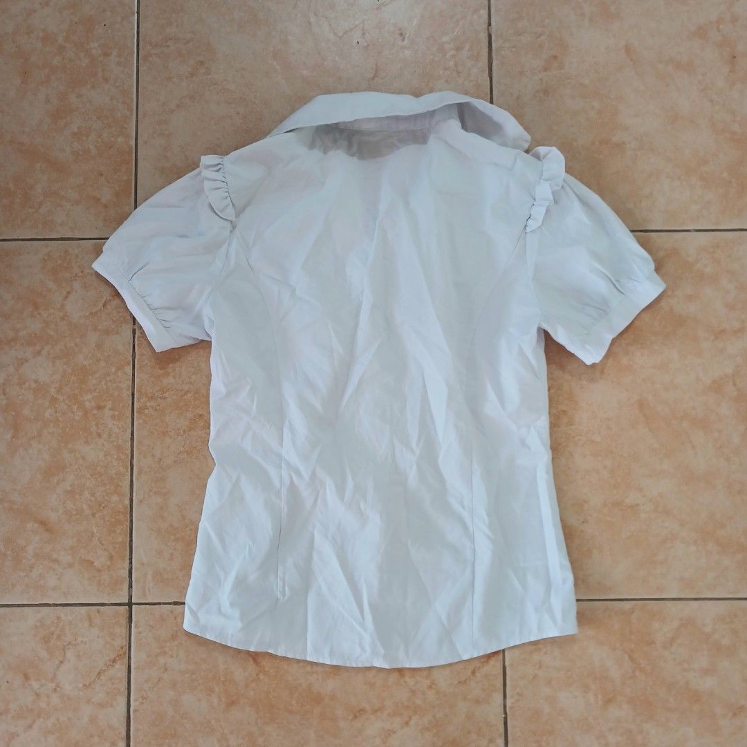 White buttondown (Category: Blouses) located in Manila. Submitted by planetaria03690 (Listing ID 1342542658, Image 2). Description: Cute White BTD (can be used for jirai kei tbh) Tags says L but fits S-M *thrifted Rfs: decluttering; not in NCR rn and will be bringing the items with me when I get back on January 4 MOP: Gcash Delivery: Lalamove c/o buyer.