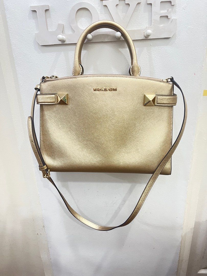 Michael Kors sling/hand bag in Gold (Category: Luxury Bags & Wallets) located in Pasig City. Submitted by true_solutionx (Listing ID 1339464528, Image 1). Description: Michael Kors Sling/Hand bag in Gold Two Big compartments Bought in US.