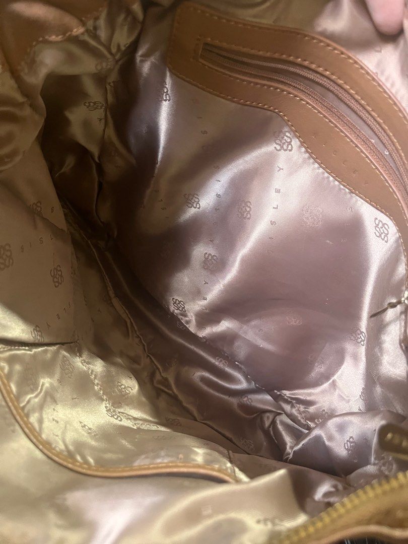 SISLEY brown shoulder bag (Category: Shoulder Bags) located in Marikina City. Submitted by declutterisse (Listing ID 1342747519, Image 3). Description: Barely used. Slightly negotiable. Flaw: theres a crack mark on one of the hidden pockets (see photo) but other than that, bag is in great shape..