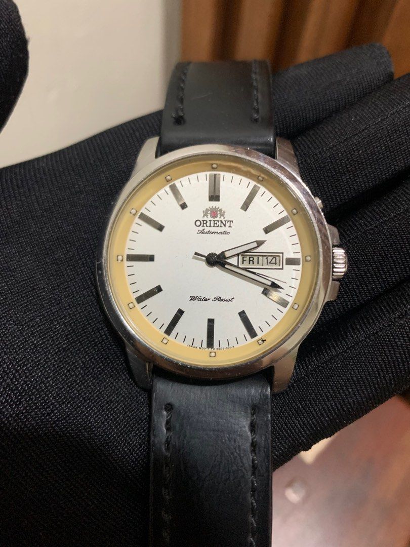 Vintage Orient Watch - Automatic Day-Date - White Dial (Category: Men's Watches) located in Dasmarinas. Submitted by phamhannii (Listing ID 1343097250, Image 2). Description: Vintage Orient Automatic Watch EM7J-C4-A 41mm Day-Date White Dial Leather Strap (Aftermarket) Excellent Running Condition Water Resist Comes w/ free replacement box Dial Condition: 8.5/10 (yellowing and minimal chip on the edges) Overall Condition: 9.2/10 Great Condition Neg