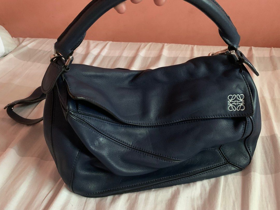 Loewe Puzzle bag (Medium) (Category: Luxury Bags & Wallets) located in Davao. Submitted by chirella17 (Listing ID 1344219972, Image 1). Description: genuine leather silver-tone hardware color navy blue detachable/adjustable strap embossed anagram logo -Shows normal signs of use including internal wear, oxidation, scratches or marks on surface and hardware. This bag is in good pre-owned condition..