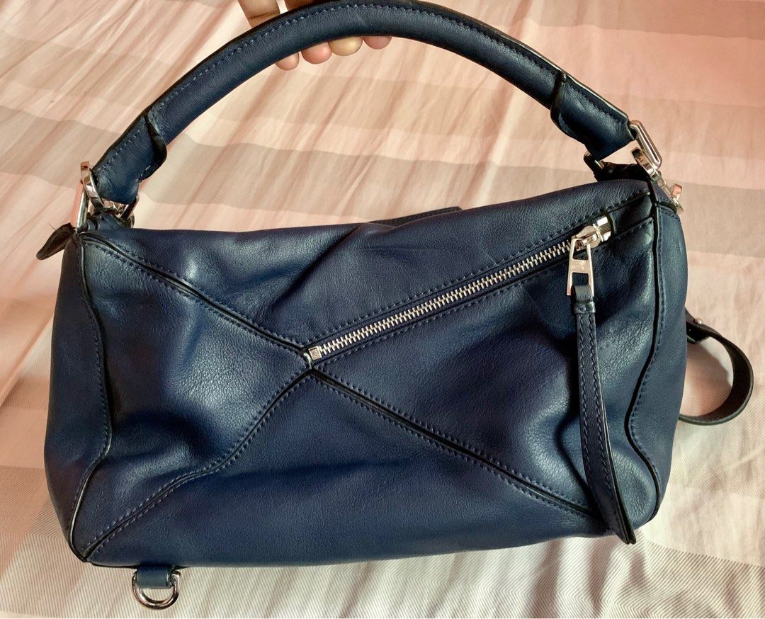 Loewe Puzzle bag (Medium) (Category: Luxury Bags & Wallets) located in Davao. Submitted by chirella17 (Listing ID 1344219972, Image 2). Description: genuine leather silver-tone hardware color navy blue detachable/adjustable strap embossed anagram logo -Shows normal signs of use including internal wear, oxidation, scratches or marks on surface and hardware. This bag is in good pre-owned condition..