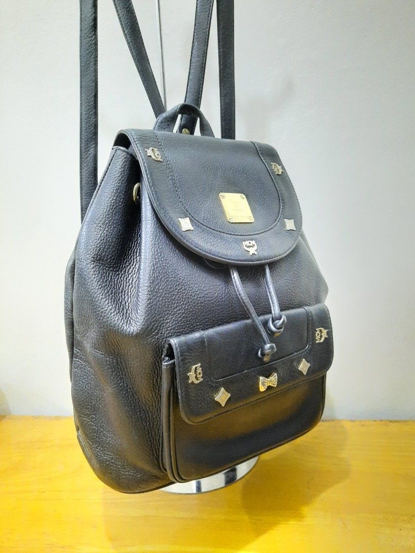 MCM Backpack Leather Germany (Category: Luxury Bags & Wallets) located in Valenzuela. Submitted by one.touch (Listing ID 1344200864, Image 2). Description: 👜MCM BACKPACK 👜BLACK LEATHER w/ GOLD STUDS ✅PRELOVED/USED ✅Good Condition ✅Few tarnish on hardware ✅Very Good Leather Condition ✅Medium size 13x12 inches ✅Draw String Clousure ✅Shoulder Leather Strap ✅Canvass lining 📍Loc: Valenzuela City 🛵Courier: LBC/Lalamove/J&T 💸Payment First 🚫No COD.