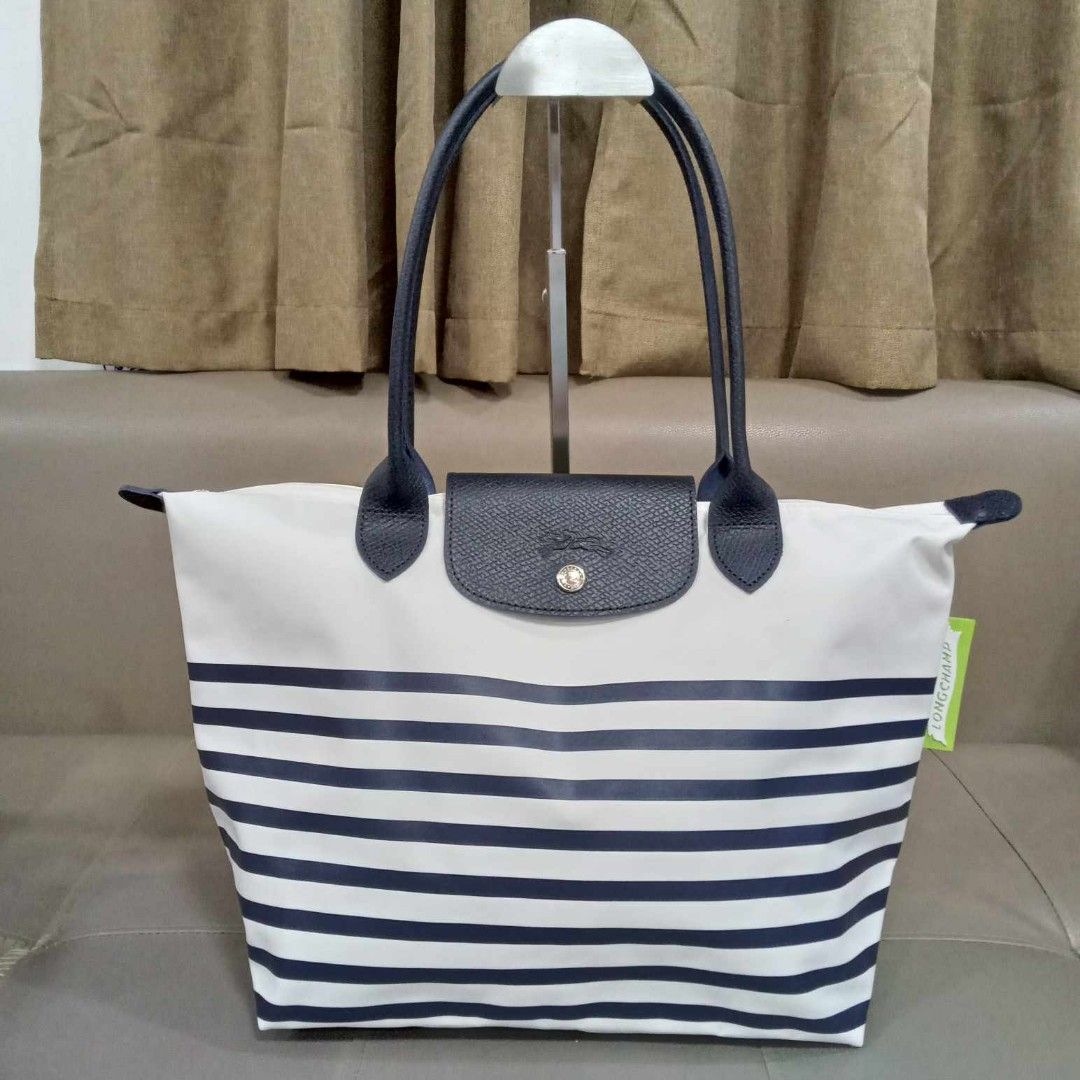 Longchamp Medium Nylon Tote (Category: Luxury Bags & Wallets) located in Taguig. Submitted by esa.agustin (Listing ID 1339623643, Image 1). Description: Original Longchamp medium white with blue stripes tote bag. With carecards..