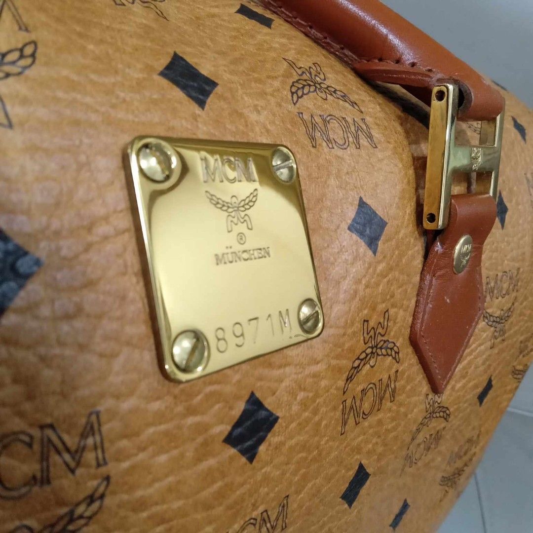 MCM Cognac Boston Travel Bag 40 (Category: Luxury Bags & Wallets) located in Taguig. Submitted by esa.agustin (Listing ID 1339601073, Image 3). Description: Original MCM Cognac monogram boston travel bag. Size 40 cm. With original strap. Made in Germany..