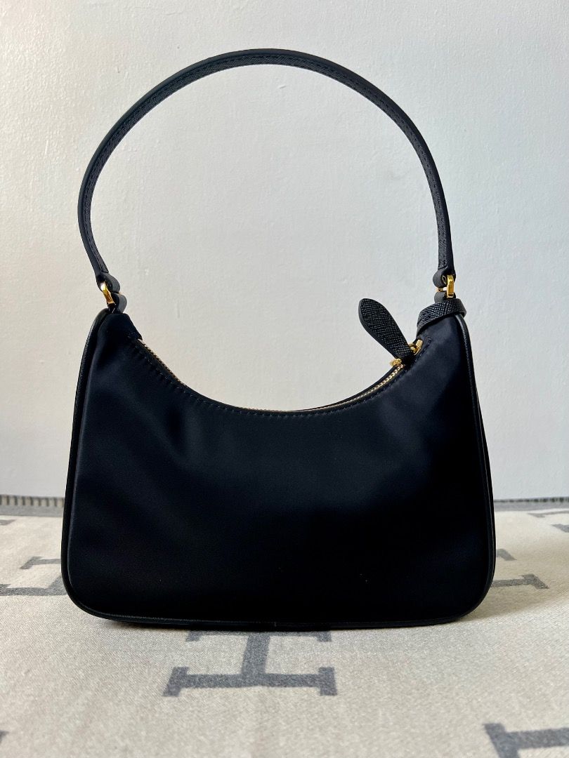 Prada Re-Edition 2005 Hobo Nylon Black Bag (Category: Luxury Bags & Wallets) located in Antipolo. Submitted by chanchimj (Listing ID 1331384020, Image 2). Description: Prada Hobo Re-Edition 2005 Leather Wrist Underarm Bag 1N204 Hobo underarm bag has become a mainstream fashion trend! Super versatile and beautiful, fashionable people must buy it! Not only practical, light and beautiful. Size: 22*18*6.5 Black and gold hardware.