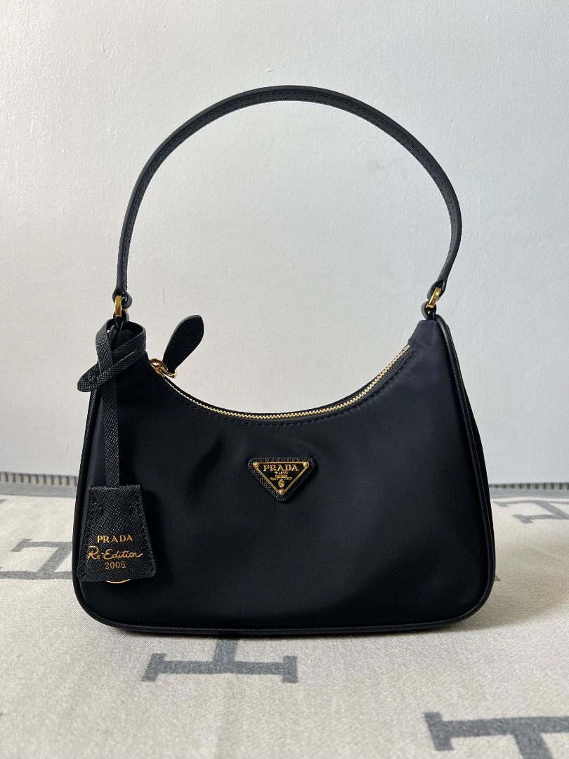 Prada Re-Edition 2005 Hobo Nylon Black Bag (Category: Luxury Bags & Wallets) located in Antipolo. Submitted by chanchimj (Listing ID 1331384020, Image 1). Description: Prada Hobo Re-Edition 2005 Leather Wrist Underarm Bag 1N204 Hobo underarm bag has become a mainstream fashion trend! Super versatile and beautiful, fashionable people must buy it! Not only practical, light and beautiful. Size: 22*18*6.5 Black and gold hardware.
