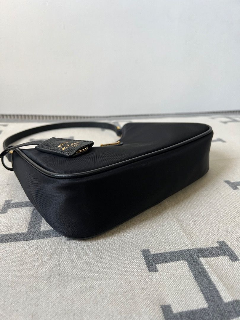 Prada Re-Edition 2005 Hobo Nylon Black Bag (Category: Luxury Bags & Wallets) located in Antipolo. Submitted by chanchimj (Listing ID 1331384020, Image 3). Description: Prada Hobo Re-Edition 2005 Leather Wrist Underarm Bag 1N204 Hobo underarm bag has become a mainstream fashion trend! Super versatile and beautiful, fashionable people must buy it! Not only practical, light and beautiful. Size: 22*18*6.5 Black and gold hardware.