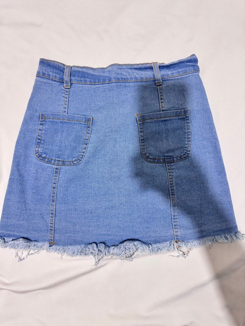 [Preloved] Buttondown Ripped Denim Skirt (Category: Skirts) located in Bacoor. Submitted by amorousmnl (Listing ID 1344533964, Image 3). Description: Good condition; no issues Size: S-M Stretchable Exact Measurements: Bottom Waist: 26" Hips: 30" Length: 15" RFS: Declutter.