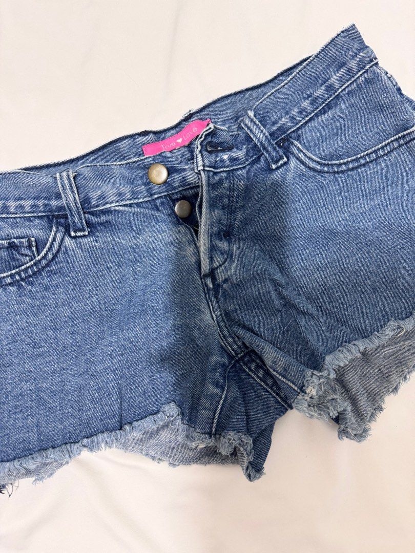 [Preloved] Low-waisted Ripped Denim Shorts (Category: Shorts) located in Bacoor. Submitted by amorousmnl (Listing ID 1344531896, Image 1). Description: Good condition; no issues Size: S-M Exact Measurements: Bottom Waist: 30" Hips: 32" Thigh: 20" Length: 10" RFS: Declutter.