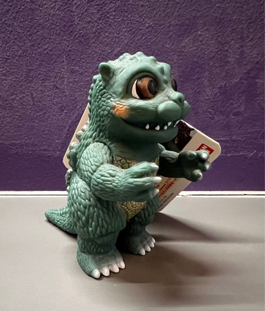 Bandai Little Godzilla (Category: Toy Figures) located in Singapore. Submitted by cards_n_collectibles (Listing ID 1344741743, Image 2). Description: Made in 2021 by Bandai, this little godzilla is from the Godziban puppet series. The figure is around 4 inches in height and has moveable arms and tail. What is Godziban? (Click on the link here to find out!) https://godzilla.fandom.com/wiki/Godziban#:~:text=Monster%20Puppet%20Show%20Godziban%20(怪獣,