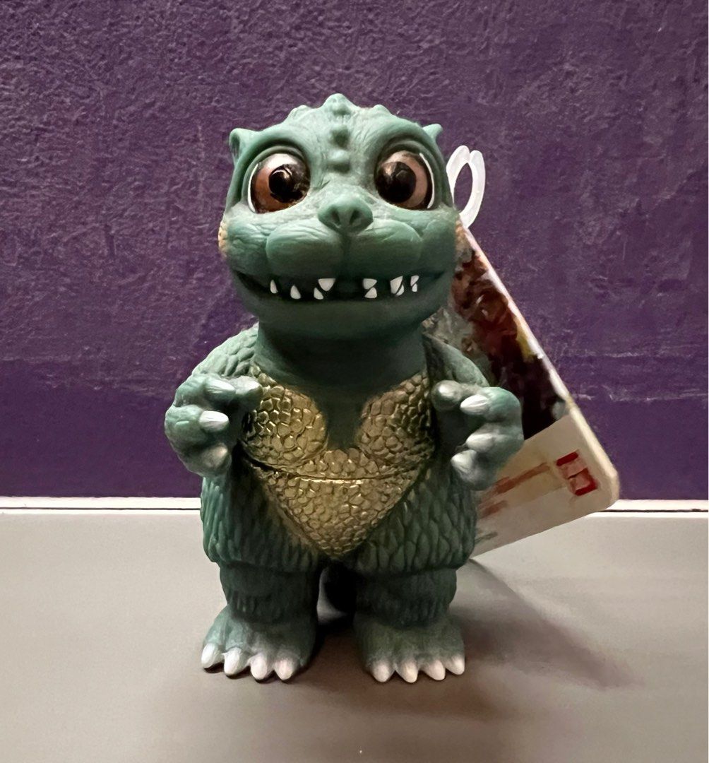 Bandai Little Godzilla (Category: Toy Figures) located in Singapore. Submitted by cards_n_collectibles (Listing ID 1344741743, Image 1). Description: Made in 2021 by Bandai, this little godzilla is from the Godziban puppet series. The figure is around 4 inches in height and has moveable arms and tail. What is Godziban? (Click on the link here to find out!) https://godzilla.fandom.com/wiki/Godziban#:~:text=Monster%20Puppet%20Show%20Godziban%20(怪獣,