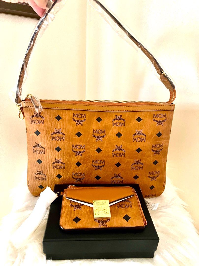 MCM Pochette & Card Case Set (Category: Luxury Bags & Wallets) located in Angeles City. Submitted by beautyforkeeps (Listing ID 1340016269, Image 1). Description: Brand New - MCM Visetos Pouch and Zip Card Case ! 💯Authentic from 🇺🇸 1. MCM Visetos Monogram Zip Pouch with leather shoulder strap (pouch was from Liz Medium Tote) no dust bag! Price: php 12k 2. MCM Patricia Visetos Zip Card Case Price: php 17k Dimensions: 4.9”W x 0.6”D x 3.2”H Zip c