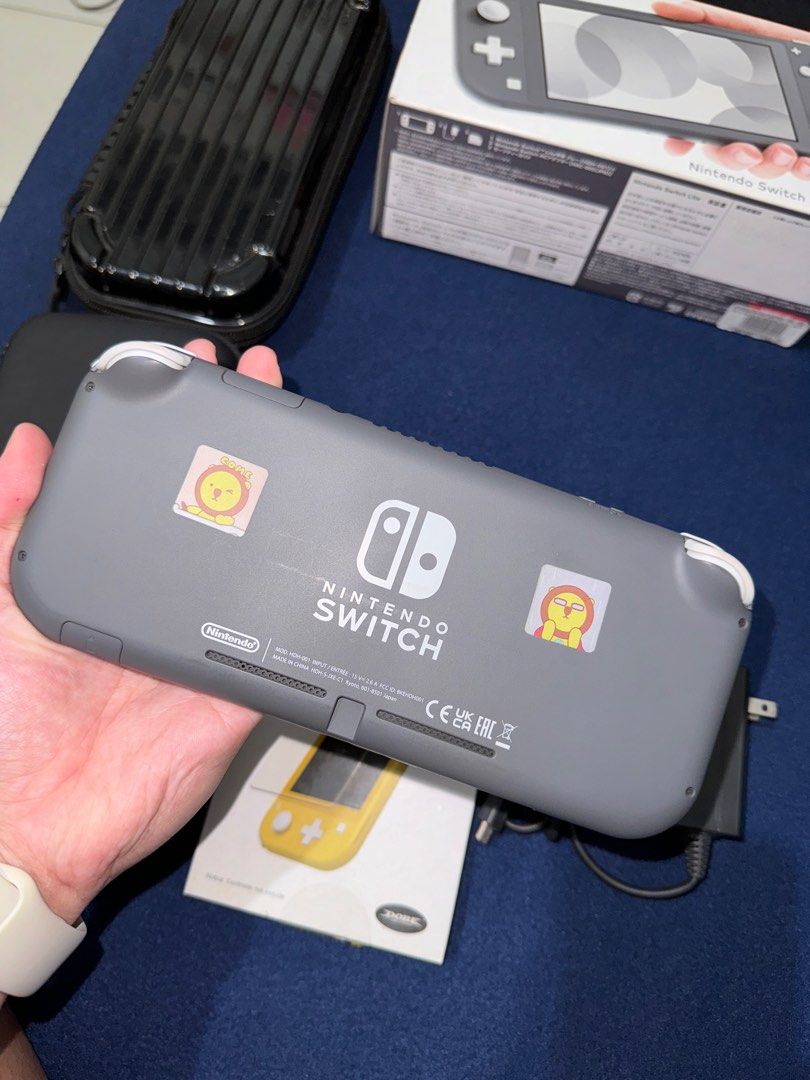 Nintendo Switch Lite (Category: Nintendo) located in Pasig City. Submitted by shanemendozaa (Listing ID 1340082566, Image 2). Description: Nintendo Switch Lite In Gray Box, charger, glass film, & 2 cases included. .