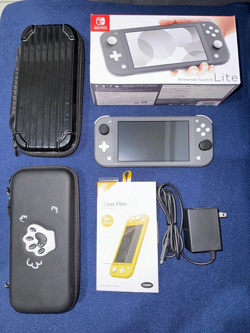 Nintendo Switch Lite (Category: Nintendo) located in Pasig City. Submitted by shanemendozaa (Listing ID 1340082566, Image 1). Description: Nintendo Switch Lite In Gray Box, charger, glass film, & 2 cases included. .