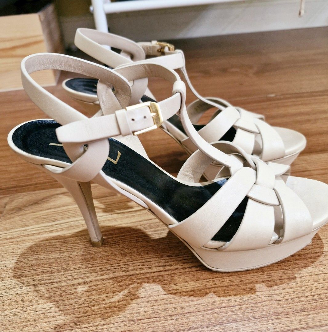 YSL Tribute platform sandals in smooth leather (Category: Heels) located in San Juan City. Submitted by loreleigtan (Listing ID 1340030509, Image 3). Description: Authentic YSL high heels platform sandals with intertwining straps, featuring a beveled platform, covered heel and adjustable ankle strap engraved with Saint Laurent Paris. Leather sole with vibram shoe protector total heel height: 13.5 cm / 5.3 inches arch height: 10.5 cm / 4.1 inches 