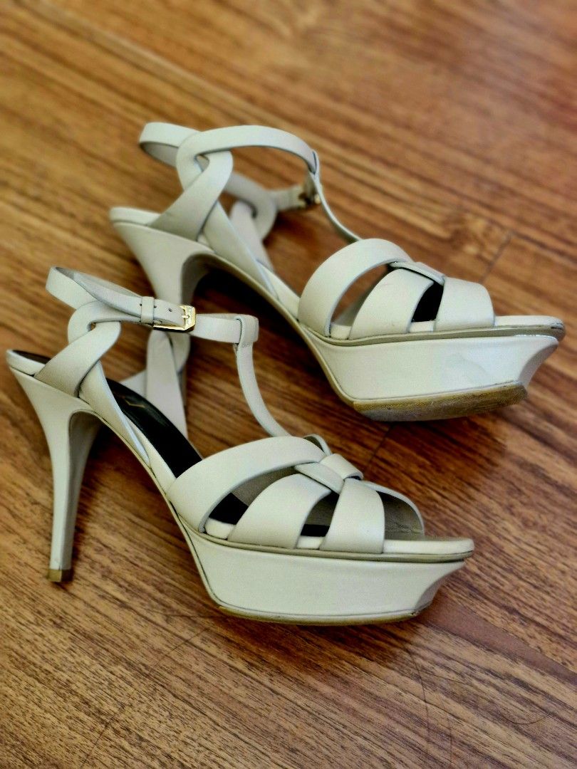 YSL Tribute platform sandals in smooth leather (Category: Heels) located in San Juan City. Submitted by loreleigtan (Listing ID 1340030509, Image 2). Description: Authentic YSL high heels platform sandals with intertwining straps, featuring a beveled platform, covered heel and adjustable ankle strap engraved with Saint Laurent Paris. Leather sole with vibram shoe protector total heel height: 13.5 cm / 5.3 inches arch height: 10.5 cm / 4.1 inches 
