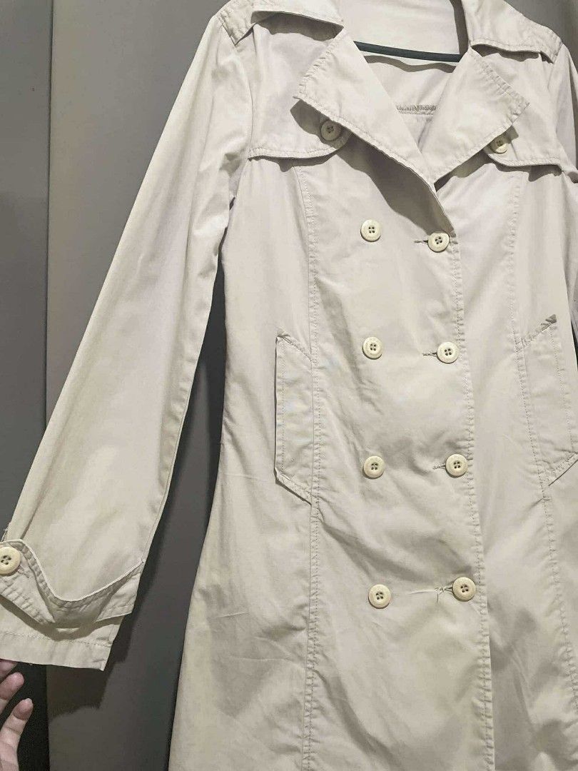 RRJ Double-breasted classic trench coat (Category: Coats, Jackets and Outerwear) located in Rizal. Submitted by oncelovedbysherry (Listing ID 1340511079, Image 3). Description: Beige double-breasted trench coat with wide lapels and 2 working pockets. Lightweight. Classic trench coat styling with adjustable straps on the sleeves. Bought this in the physical store. Never used. RFS: Too tight in my arms 🥲 SF will be shouldered by buyer. Length: 33 