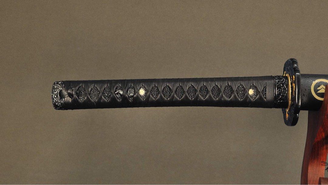 Ghost of Tsushima Katana (Category: Combat Sports) located in Manila. Submitted by rexngaw (Listing ID 1340752469, Image 3). Description: Ghost of Tsushima Katana -Exact replica of Jin Sakai’s katana except in all black -1095 HC DH Steel -Leather Tsukaito (handguard) -only used for display purposes -repainted tsuba (handguard) -will include double katana display stand -forged and imported from Thailand.