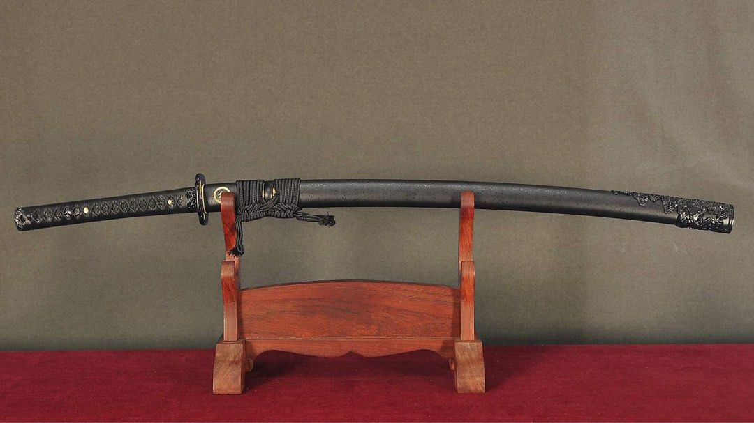 Ghost of Tsushima Katana (Category: Combat Sports) located in Manila. Submitted by rexngaw (Listing ID 1340752469, Image 2). Description: Ghost of Tsushima Katana -Exact replica of Jin Sakai’s katana except in all black -1095 HC DH Steel -Leather Tsukaito (handguard) -only used for display purposes -repainted tsuba (handguard) -will include double katana display stand -forged and imported from Thailand.