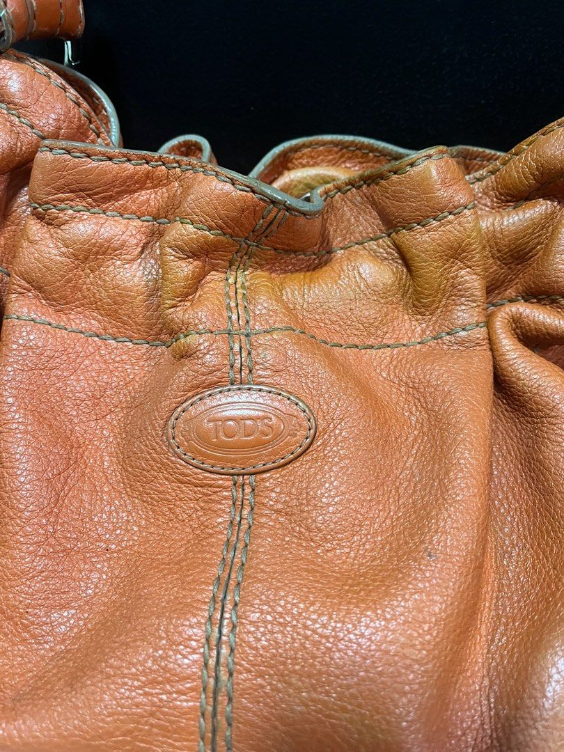 Authentic Tods Bucket Shoulder Bag (Category: Luxury Bags & Wallets) located in Quezon City. Submitted by bebegaze (Listing ID 1283496433, Image 3). Description: Authentic Tods bag Preloved so expect signs of use such as rubs, discoloration and ink stain inside. Very soft leather. Super nice material. .