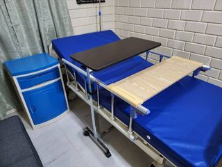 Hospital bed with bedside cabinet and more