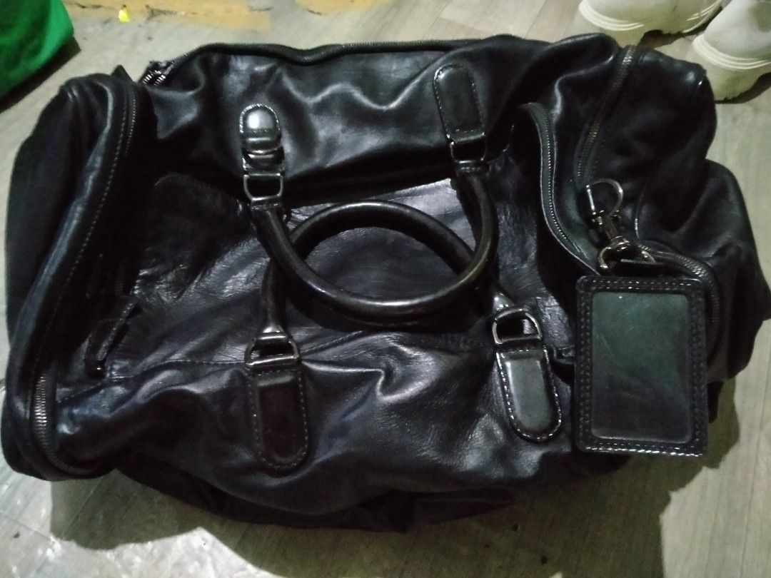 Lanvin travel bag (Category: Luxury Bags & Wallets) located in Manila. Submitted by palangga. (Listing ID 1283514151, Image 3). Description: na stock lang sa cabinet at nabaklas po ang gilid ng pocket sa loob ng bag. attention Last year, while I was cleaning the stock room, the bag accidentally fell. My fur babies ended up playing with it, causing a few minor scratches on the bottom of the bag." please po sa mga buyer huwag mag papaasa kung Hindi