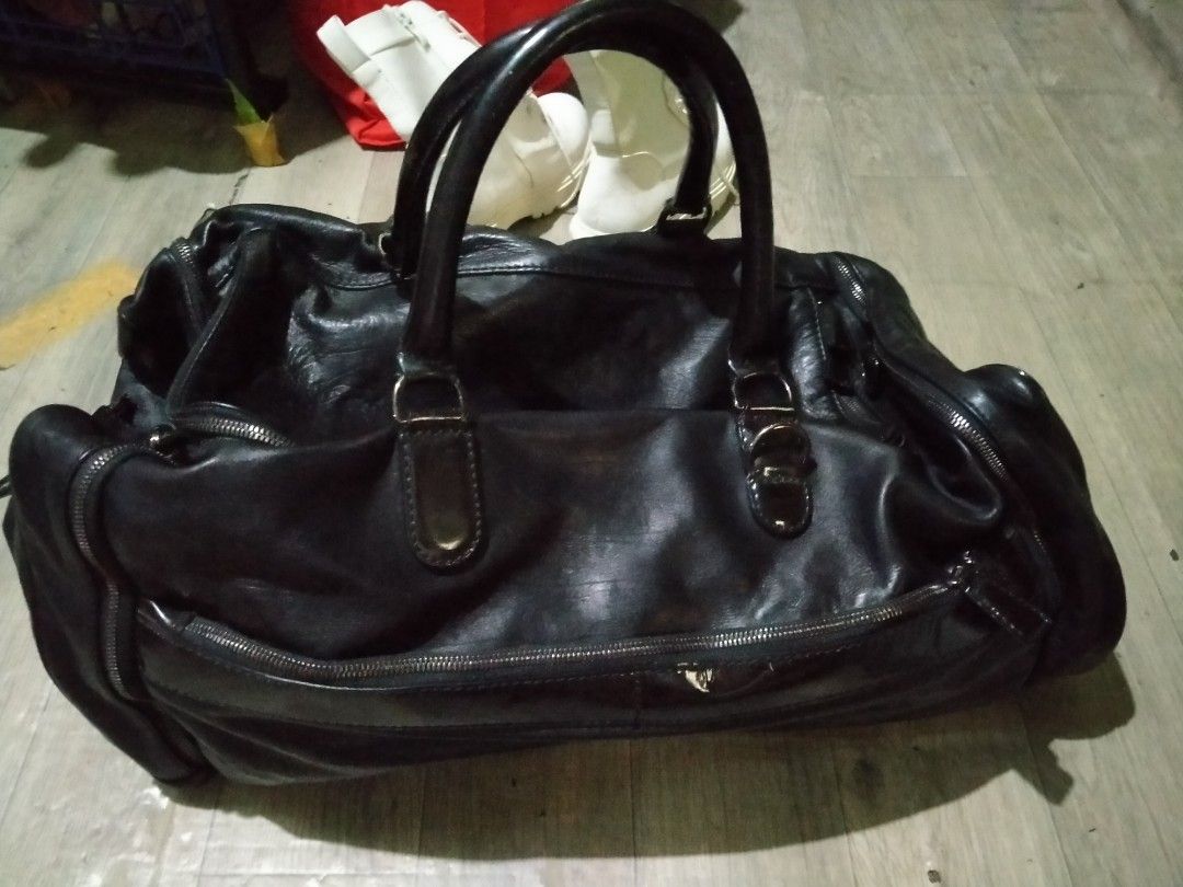 Lanvin travel bag (Category: Luxury Bags & Wallets) located in Manila. Submitted by palangga. (Listing ID 1283514151, Image 1). Description: na stock lang sa cabinet at nabaklas po ang gilid ng pocket sa loob ng bag. attention Last year, while I was cleaning the stock room, the bag accidentally fell. My fur babies ended up playing with it, causing a few minor scratches on the bottom of the bag." please po sa mga buyer huwag mag papaasa kung Hindi