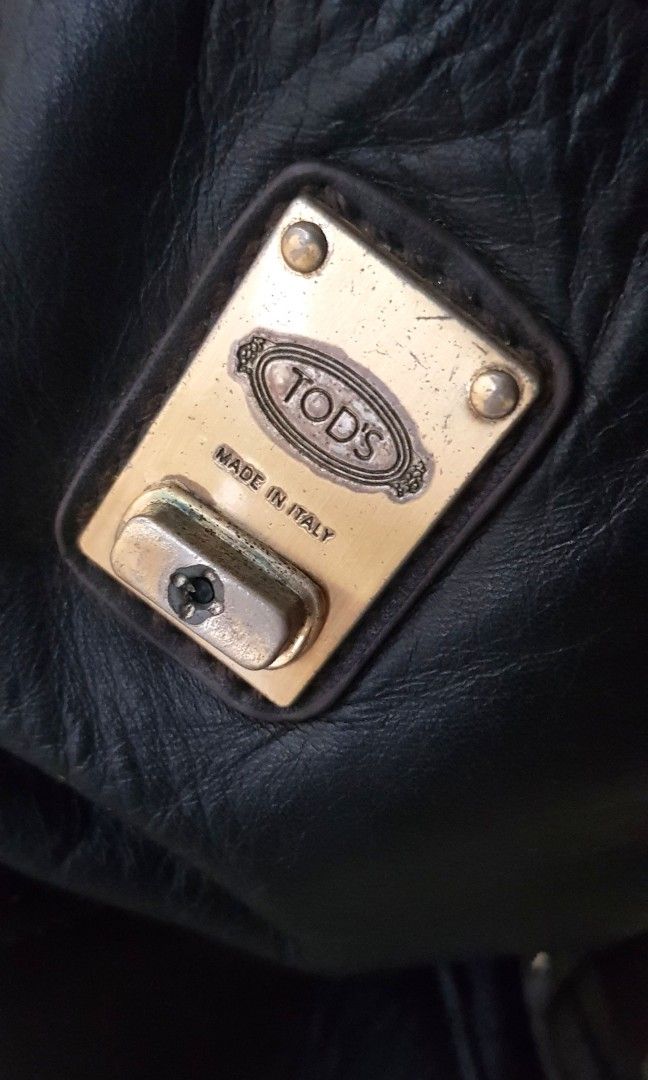 Vintage Tods D Styling Leather Bag (Category: Luxury Bags & Wallets) located in Quezon City. Submitted by happycheeeks (Listing ID 1283456596, Image 3). Description: 💯handsome in actual. All leather. Brass hardware. Can fit a lot flaws shown on pics 1. handle 2. broken turnlock 3. missing strap 14.75 inches - length 16 inches- height incl handle 6.75 inches - depth rfs decluttering manage your expectations needs cleaning, polishing of hardware s