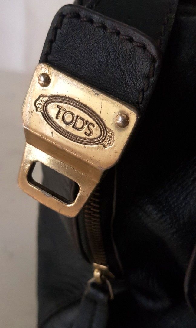 Vintage Tods D Styling Leather Bag (Category: Luxury Bags & Wallets) located in Quezon City. Submitted by happycheeeks (Listing ID 1283456596, Image 2). Description: 💯handsome in actual. All leather. Brass hardware. Can fit a lot flaws shown on pics 1. handle 2. broken turnlock 3. missing strap 14.75 inches - length 16 inches- height incl handle 6.75 inches - depth rfs decluttering manage your expectations needs cleaning, polishing of hardware s