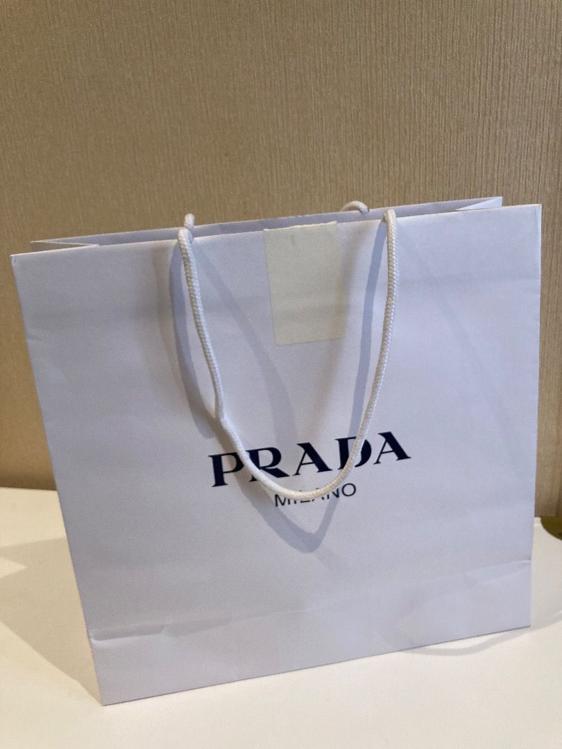 Authentic Prada Outlet Paper Bag (Category: Luxury Bags & Wallets) located in Manila. Submitted by theocclosetmanila (Listing ID 1285903196, Image 2). Description: Authentic Prada outlet paper bag for medium sized bags. Flaws are as seen on photos. I have two of these bags, you can get both for a discount. Size: 35 x 36 x 12 cm Comes from a pet free and smoke free home. DM for inquire. Additional photos will only be sent to serious buyers. .