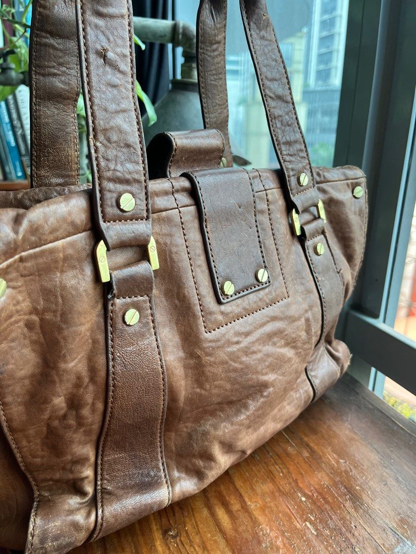 Authentic Burch Genuine Distressed Leather Brown Shoulder Tote Bag - medium (Category: Luxury Bags & Wallets) located in Quezon City. Submitted by vianca13 (Listing ID 1285870146, Image 3). Description: Genuine Leather Tory Burch Tote Bag - distressed leather vintage look finish - gold hardware - can fit 13 inch laptop - edgy and classic - gold plate, turnable screw - authentic #genuineleather #toryburchtote #officebag #officetote #toryburch #bro