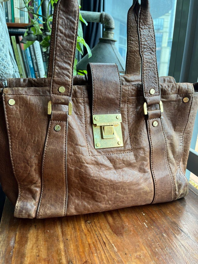 Authentic Burch Genuine Distressed Leather Brown Shoulder Tote Bag - medium (Category: Luxury Bags & Wallets) located in Quezon City. Submitted by vianca13 (Listing ID 1285870146, Image 2). Description: Genuine Leather Tory Burch Tote Bag - distressed leather vintage look finish - gold hardware - can fit 13 inch laptop - edgy and classic - gold plate, turnable screw - authentic #genuineleather #toryburchtote #officebag #officetote #toryburch #bro