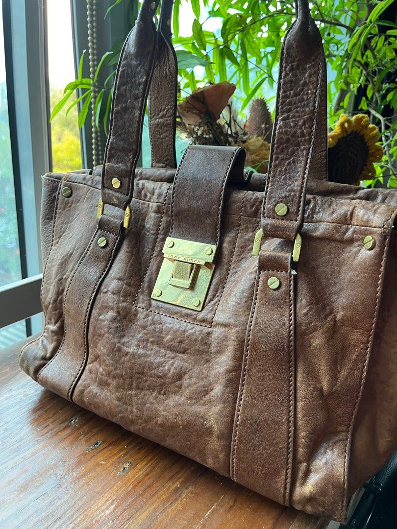 Authentic Burch Genuine Distressed Leather Brown Shoulder Tote Bag - medium (Category: Luxury Bags & Wallets) located in Quezon City. Submitted by vianca13 (Listing ID 1285870146, Image 1). Description: Genuine Leather Tory Burch Tote Bag - distressed leather vintage look finish - gold hardware - can fit 13 inch laptop - edgy and classic - gold plate, turnable screw - authentic #genuineleather #toryburchtote #officebag #officetote #toryburch #bro