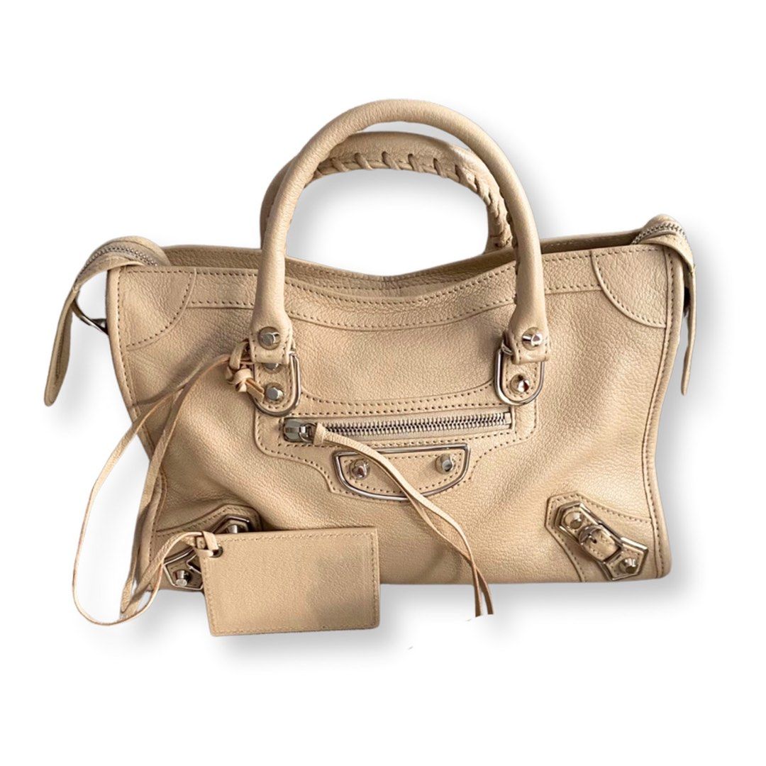 BALENCIAGA Metallic Small Edge SHW (Category: Luxury Bags & Wallets) located in Makati City. Submitted by justeprix (Listing ID 1286139103, Image 1). Description: ✅ NO ISSUES ✅ You can send a reasonable offer PRICE NEGOTIABLE DROP YOUR OFFER BUT BE REALISTIC 😉😉😉 - Beige cream-colored goatskin leather with silver hardware - Lightly used with care - Like NEW - With dust bag, bag strap, mirror and tags - RFS: Decluttering PM us for more inquiries