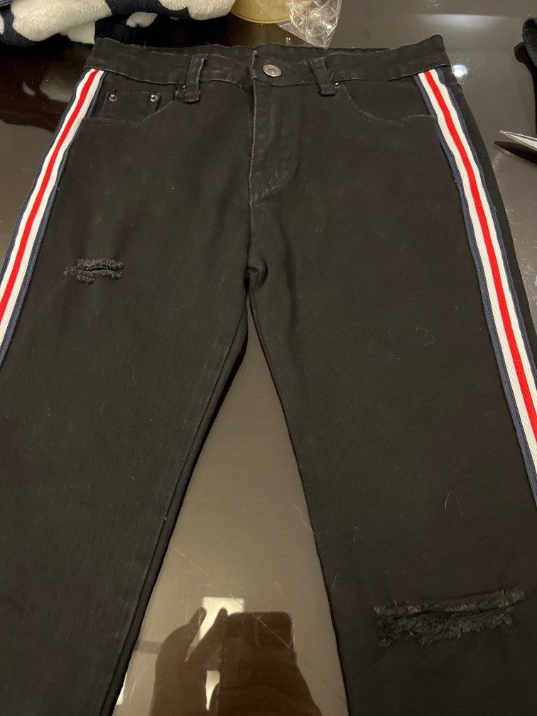 BLACK JEANS WITH RED AND WHITE STRIPES DETAILS ON THE SIDE