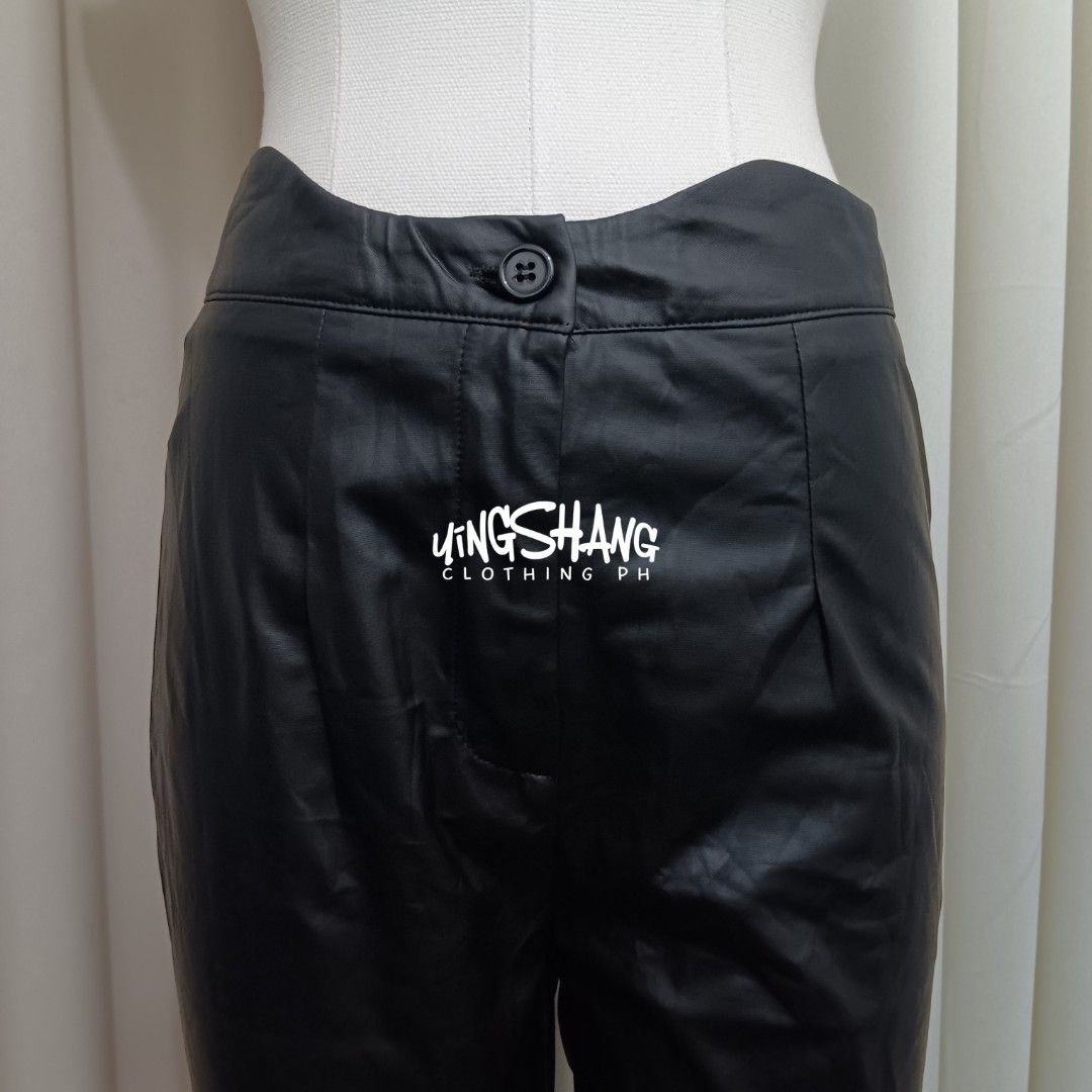 SHEIN Leather Solid Black Fitted Trouser Pants (Category: Jeans) located in Mandaluyong City. Submitted by yingshangclothingph (Listing ID 1286744489, Image 2). Description: SHEIN LEATHER PANTS Size on tag: Medium (28-30 in) Length: 40 in Fabric: Leather (slight-stretch) Color: Black Details: Button, Zipper.