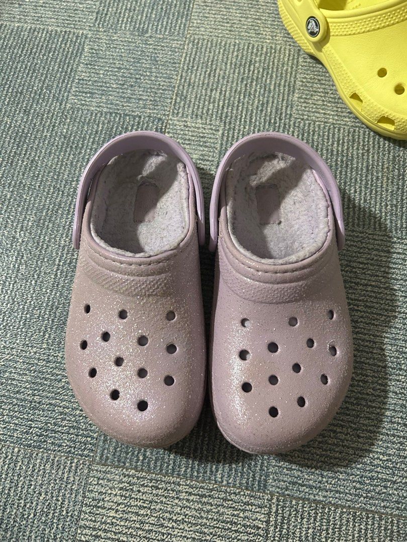 Preloved authentic crocs glitter lined clogs size J1 (Category: Babies & Kids Fashion) located in San Jose del Monte. Submitted by devski (Listing ID 1287257795, Image 1). Description: US bought Glitter lined clogs Color lavender Size J1 (or US1) Already washed pero pwede mo ulit labhan if medyo maselan :) No heel drags, rarely used by my kid Rfs : outgrown.