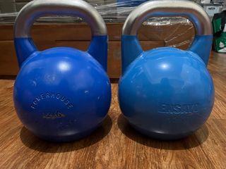 a pair of 12kg Competition Kettlebell with Gym Rubber Mats