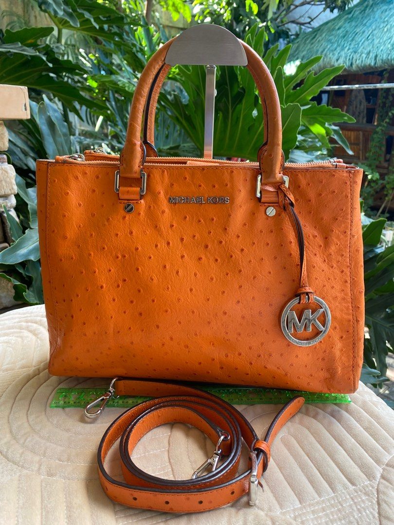MICHAEL KORS 2-Way Bag (Category: Luxury Bags & Wallets) located in Baliuag. Submitted by nylinel (Listing ID 1287552834, Image 1). Description: Material in orange ostrich leather Hardware in silver tone Size: L- 12.5” x H- 9” x W- 4” Guaranteed Original 💯 Outside in very good condition Inside with leather stains on zipper side.