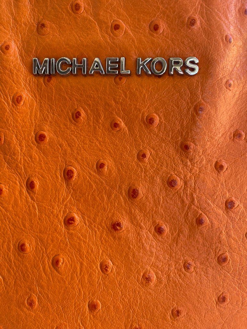 MICHAEL KORS 2-Way Bag (Category: Luxury Bags & Wallets) located in Baliuag. Submitted by nylinel (Listing ID 1287552834, Image 2). Description: Material in orange ostrich leather Hardware in silver tone Size: L- 12.5” x H- 9” x W- 4” Guaranteed Original 💯 Outside in very good condition Inside with leather stains on zipper side.