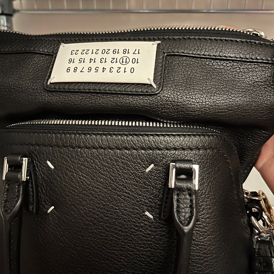 Maison Margiela 5ac classique mini bag (Category: Bags & Wallets) located in Singapore. Submitted by ritsushin (Listing ID 1287851523, Image 3). Description: a few ways to wear it - pic 1/2 - pic 6 - sling or top handle bag Outer: Goat leather with soft touch Lining: Polyester Application: Calf leather Polished metal hardware Detachable and adjustable shoulder strap Logo label at the front Lock and key with logo Double zip to fold the head of the