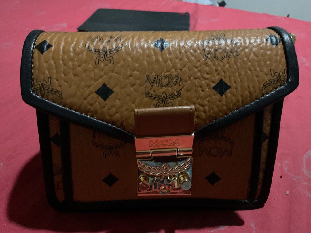 MCM Patricia Cross body bag (Category: Luxury Bags & Wallets) located in Quezon City. Submitted by challizomorog (Listing ID 1287797495, Image 2). Description: MCM Patricia cross body bag Two way 100% Gold hardware with white tag turnable screws In cognac and black with MCM dust bag RFS: Bought MCM Toni Mini shopper.