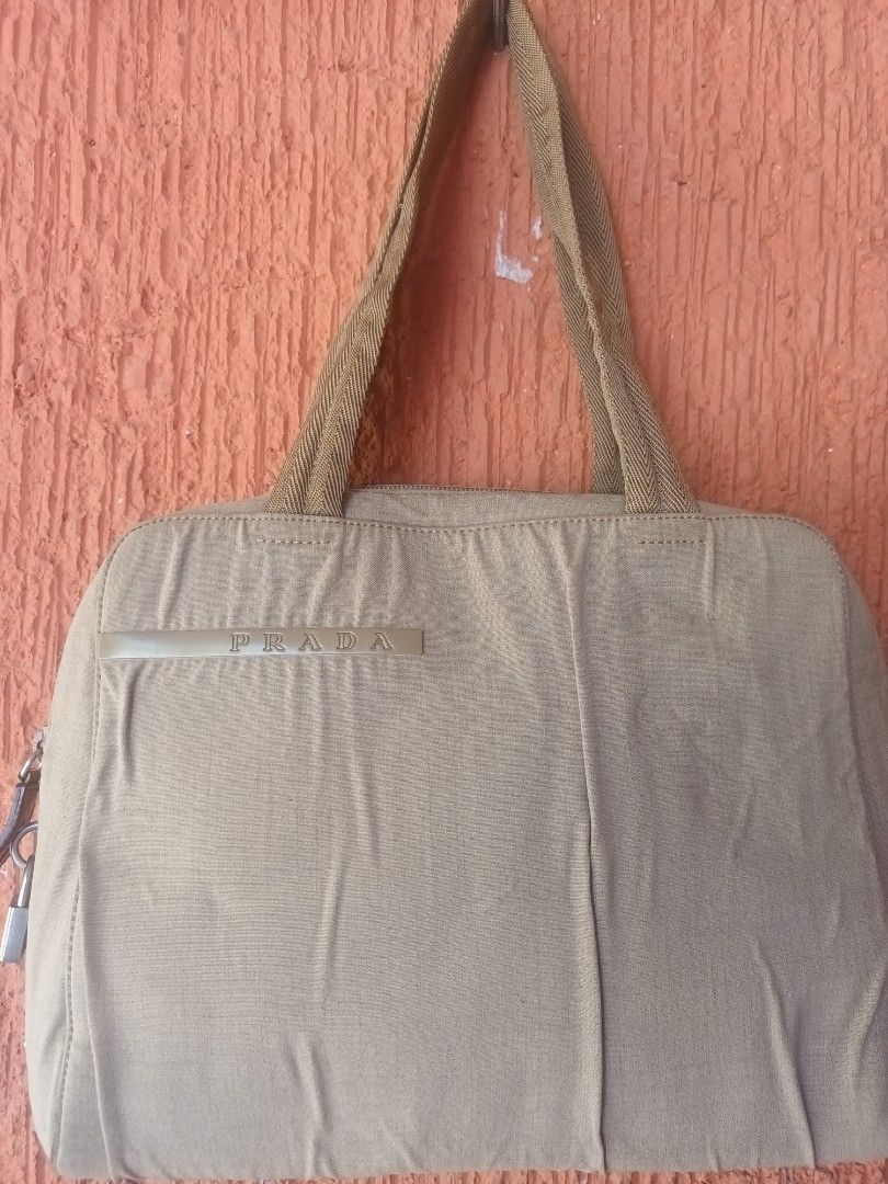 Preloved Prada Nylon Sport Handbag (Category: Luxury Bags & Wallets) located in Mandaluyong City. Submitted by keanqd (Listing ID 1287693529, Image 2). Description: Prada Nylon Sport Handbag with Padlock Authentic with some crumpled- nalabhan ko kasi siya a little stains h-9 inches l- 12 inches w- 2.5 inches shipping c/o buyer.