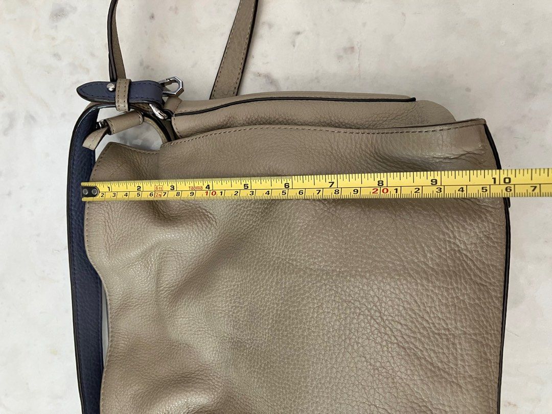Oryany Leather Bucket Shoulder Sling Bag (Category: Cross-body Bags) located in Manila. Submitted by zolnak (Listing ID 1287927056, Image 2). Description: Very good condition. Real cream soft pebbled leather. Imported brand. Drawstring with metal locking hardware. All silver hardware in almost perfect condition. With short handle and adjustable sling strap. Additional punched strap hole. Minimal small unnoticeable stain as shown in photos. Cute c