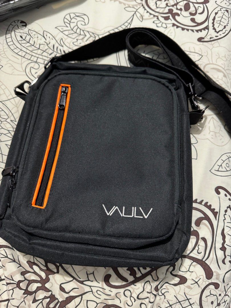 VAULV ESSENTIAL 012 (BLACK-ORANGE) (Category: Sling Bags) located in Cavite. Submitted by jaybee28 (Listing ID 1288043360, Image 1). Description: VAULV ESSENTIAL 012 (BLACK-ORANGE) The VAULV Essential 012 is the go-to side bag perfect for your active lifestyle. It has two main compartments where each has its own respective pockets to help further organize your essentials. Below are the features of the VAULV Essential 012: First Main Compartment Z